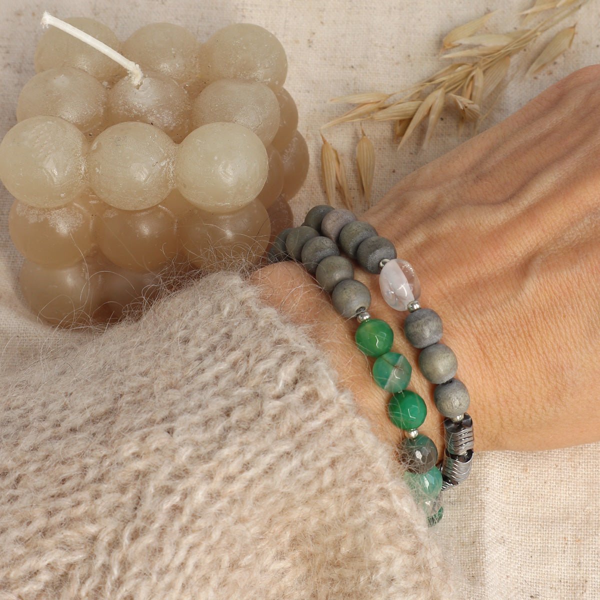 Wickel-Edelstein Armband mit grünem Achat, Bergkristall, Holzperlen und silbernem Anhänger am Handgelenk.
