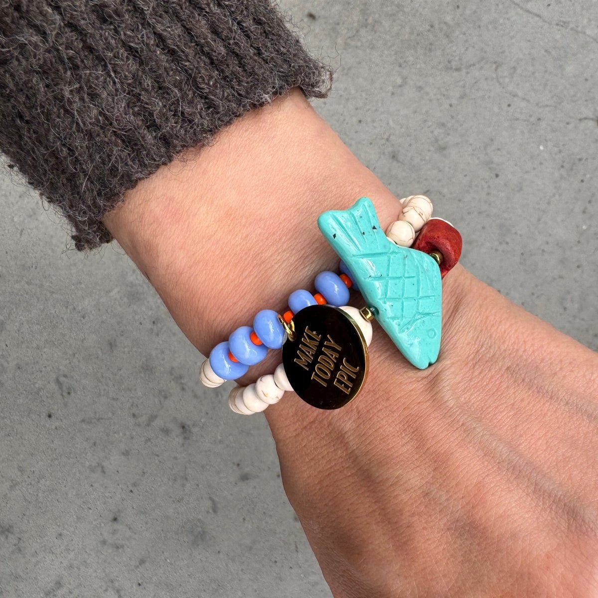 Mantra Schmuck Damen – blaues Perlenarmband mit goldenem Plättchen und türkisfarbenem Anhänger am Handgelenk